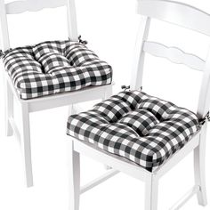 two white chairs with black and white checkered cushions