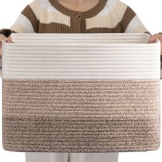 a person holding a large piece of woven material