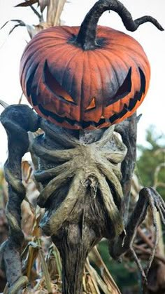 a creepy looking pumpkin sitting on top of a tree