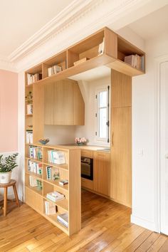 a kitchen with an open book shelf in the middle