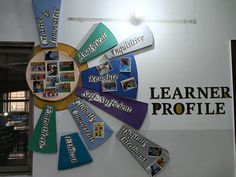 there is a sign that says learner profile on the side of a building with many pictures