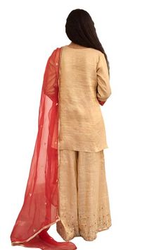 Gold kurta with placement hand embroidery. Paired with a sharara with hand embroidered hem and red dupatta with embroidered buttis. - Aza Fashions Festive Raw Silk Sharara For Ceremonial Occasion, Festive Ceremonial Raw Silk Sharara, Fitted Tussar Silk Sharara With Dupatta, Ceremonial Art Silk Sharara For Eid, Eid Ceremonial Art Silk Sharara, Festive Tussar Silk Sharara, Ceremonial Chanderi Sharara For Diwali, Ceremonial Raw Silk Sharara For Diwali, Fitted Ceremonial Sharara For Transitional Season