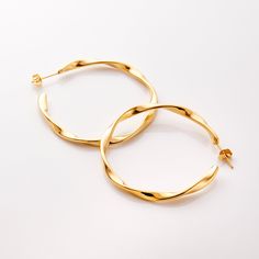 Our Ripple Hoop Earrings are inspired by the ripple effect that a pebble can cause in the ocean - these hoops stand as a reminder that you can have a ripple effect on the world with even the smallest action. Materials & Warranty Material: Real 18 karat gold plating on pure stainless steel Hypoallergenic | Sensitive Skin-Friendly Warranty: Lifetime Warranty against all rust or tarnish Packaging: Nominal Velvet Drawstring Pouch Earrings cannot be returned or exchanged due to hygienic safety