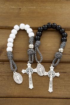 This listing includes two (2) single decade pocket rosaries. Looking for the perfect wedding gift for a newly wedded Catholic couple? Look no further than our "Together In Prayer" Paracord Rosary Set. Made with durable paracord 550 rope, these rosaries are built to last and stand the test of time, just like the couple's love for each other. Each rosary features a 2" St. Benedict crucifix making it comfortable in a pocket or purse.Each rosary also includes a Miraculous Medal, a powerful symbol of Rosary Craft, Catholic Couple, Small Rosary, Rugged Rosary, Wedding Rosary, Paracord Rosary, Rosary Jewelry, Catholic Crafts, St Benedict