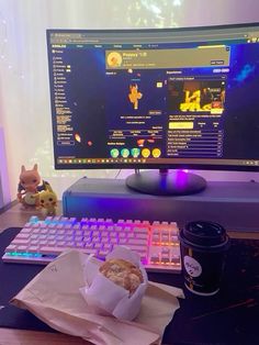 a desk with a keyboard, mouse and cup of coffee on it next to a computer monitor