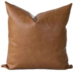 a brown leather pillow on a white background