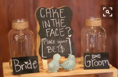 two birds are sitting in front of some glass jars with chalk writing on the sides