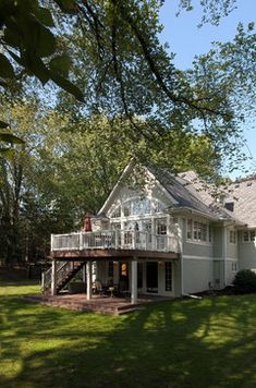 a large white house sitting on top of a lush green field