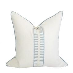 a white and blue striped pillow on a white background with a light blue stripe down the middle