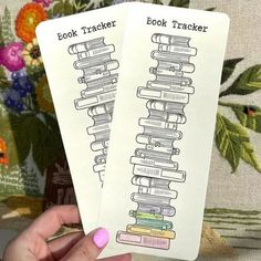 two book trackers are held up in front of a floral background, with the words'book tracker'written on them