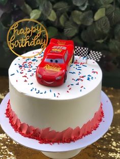 a birthday cake with a red car on top