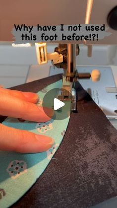 a person is using a sewing machine to sew something on the fabric with their thumbnails