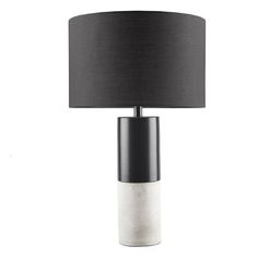 a table lamp with a black shade on the base and a grey drum light underneath it