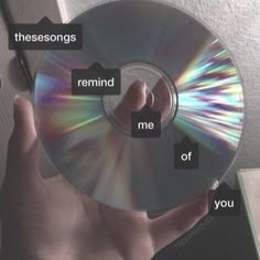 someone holding up a cd with the words, thesesongs remind me of you