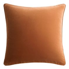 an orange pillow on a white background