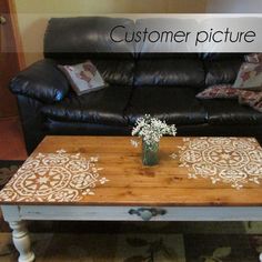 a wooden table sitting in front of a black couch