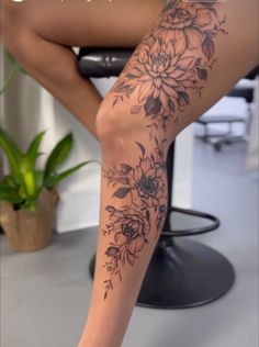 a woman's leg with flowers on it