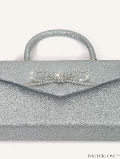 BagForLove - Silver Glitter Bow Top Handle Evening Bag - Elegant Satchel for Wedding Party Product Description Color Silver Details Rhinestone Magnetic Yes Strap Type Top Handle Pattern Type Plain Bag Size Small Closure Type Magnet Type Square Bag Material Glitter Composition 100% Polyester Size Chart INCH CM Bag Height Bag Length Bag Width Handle Height Strap Length 5.1 inch 9.1 inch 2.4 inch 3.5 inch 47.2 inch Bag Height Bag Length Bag Width Handle Height Strap Length 13 cm 23 cm 6 cm 9 cm 120 cm Details Pictures Similar Products h2 { text-align: center; } /* æ¢è¡ */ li{ white-space: normal; word-break: break-all; word-wrap: break-word; } .red-box { width: 100%; display: flex; flex-direction: row; flex-wrap: wrap; justify-content: center; } .red-box > div { width: 190px; height: 250px; Bow Top, Glitter Bow, Word Wrap, Square Bag, Silver Glitter, Evening Bags, Top Handle, 4 Inch, Wedding Party