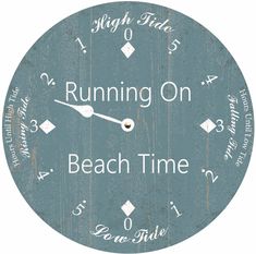 a clock with the words running on beach time