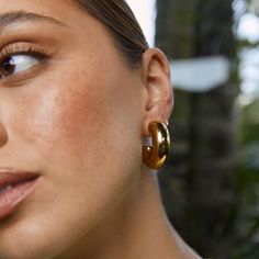 Meet the Bella Earrings, a stunning statement hoop here to add some drama to your outfit! These chunky golden hoops are truly flawless and are sure to elevate your look day or night.  Our styling tips: Pair Bella with a bold statement necklace like Isla for a stand out look. Crafted with precision, these earrings showcase a 14k gold plating (1 micron) over a stainless steel base. Finished with e-coating for added shine, they are both lead and nickel free, ensuring safe wear for all.   CARING FOR YOUR AOE JEWELS  At Arms Of Eve, we take great pride in the quality of all our jewels. All of our pieces are suitable for daily wear. Our jewels are 100% nickel and lead free. All our pieces are plated 1 microns thick in 14k Gold, as well as an e-coating for a premium finish.  In order for your jew K Drama Outfits, Thick Gold Hoop Earrings, Thick Gold Hoops, Chunky Gold Hoop Earrings, Bold Statement Necklaces, Golden Hoops, August Birthstone Jewelry, July Birthstone Jewelry, Zodiac Jewelry