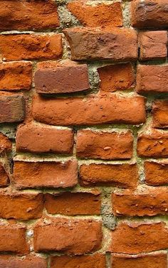 an orange brick wall is shown in close up