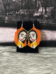 Beautiful artisan earrings handmade by Mexican artisans. Virgin of Guadalupe earrings Multicolor Our Lady Of Guadalupe Jewelry As A Gift, Multicolor Our Lady Of Guadalupe Jewelry Gift, Artisan Orange Beaded Earrings, Traditional Handmade Orange Earrings, Traditional Orange Handmade Earrings, Handmade Artisan Orange Earrings, Traditional Orange Earrings For Gift, Handmade Orange Beaded Earrings As Gift, Unique Handmade Orange Earrings