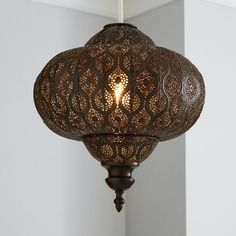 an intricately designed light fixture hangs from the ceiling