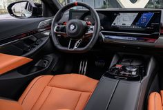 the interior of a modern car with orange leather trims and dashboard, including an entertainment system