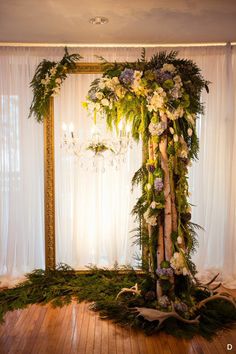 a wedding ceremony setup with flowers and greenery