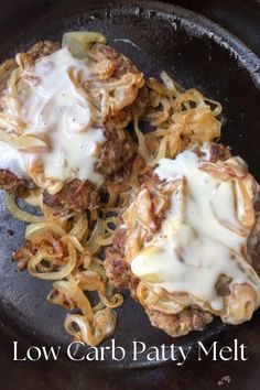 two hamburger patties covered in gravy and onions on a skillet with the words low carb patty melt