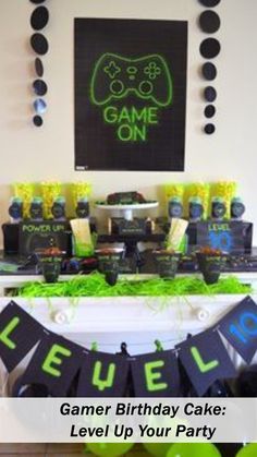 a gaming birthday cake and party decorations on a table with the words gamer birthday cake level up your party