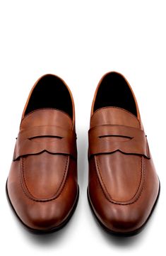 This handsome penny loafer features classic detailing for a timeless look and is supported by a sturdy rubber sole. Leather upper and lining/rubber sole Made in Portugal