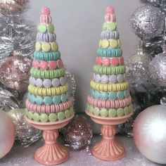 there are two decorated cakes on top of each other in front of christmas trees and ornaments