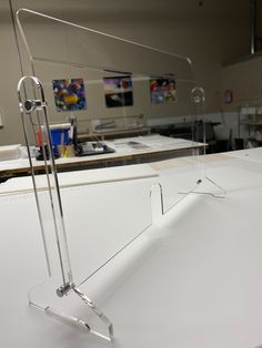 a pair of glasses sitting on top of a white counter in an office setting with other desks