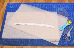 scissors and some fabric on a cutting board