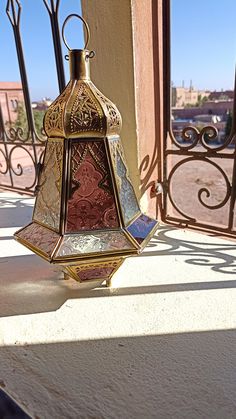 an ornate lantern is sitting on the balcony