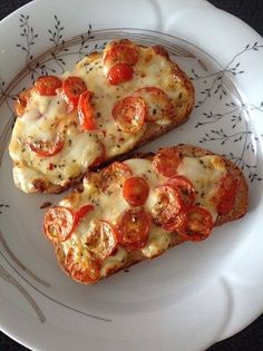 two slices of pizza on a white plate