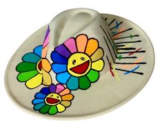 This is a hand painted Fedora The eyes of each flower are embellished with iridescent rhinestones. There are two sizes  1. inside diameter is around 22-23 inches/ 58cm 2. Inside diameter is around 24-25 inches/ 60 cm Please let me know in the notes section which size you would like There are three options  Option 1- (Dripping Flower)  flowers in the front with one dripping flower in the back with a colorful confetti like design.  Option 2 - (logo) flowers in the front with my logo on the back (KM) Option 3- ( plain Jane)  Flowers in the front with nothing on the back. The back of the hat will be plain Fedora Hats Women, Smiley Face Hat, Hawaiian Wear, White Fedora Hat, Black Fedora Hat, Women Logo, Hat Cream, Colorful Shower Curtain, Colorful Confetti