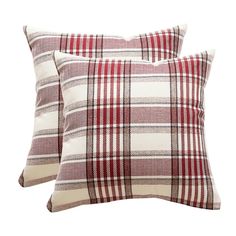 two red and white plaid pillows sitting next to each other