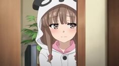 a girl with long brown hair wearing a panda hoodie and looking at the camera