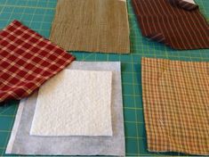 four pieces of fabric laid out on a cutting board