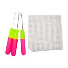 two pink and green scissors next to a pair of needle tip holders on a white background