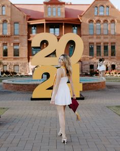 a woman standing in front of a building with the number twenty two on it's side