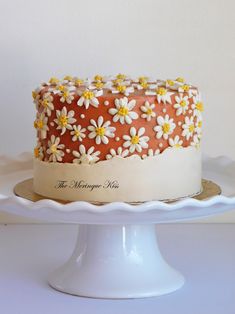 a cake with white and yellow flowers on it