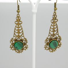 Long filigree earrings are a soft aged brass and have a green black glass stone at the bottom. These are so pretty and lightweight. The contrast of the brass and green is really nice. The earwires were missing so I did replace them. They are unmarked and in excellent condition. The drops alone measure 1 3/4 inch and from the top of the earwire to the bottom of the drop they are 2 1/4 inch. The kind of earring you find yourself reaching for all the time. Cute, dangly and comfortable. Find lots mo Ornate Bronze Metal Earrings, Green Filigree Drop Earrings, Ornate Antique Finish Earrings For Gifts, Ornate Antique Finish Earrings As Gift, Green Filigree Teardrop Earrings, Green Teardrop Metal Earrings, Green Teardrop Filigree Earrings, Antique Brass Pierced Plug Earrings, Antique Brass Plug Earrings