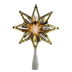 a white vase with a gold and black star decoration in it's center, against a white background