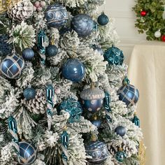 a christmas tree decorated with blue and silver ornaments