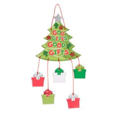 a christmas tree hanging from the ceiling with tags attached to it's sides and small presents