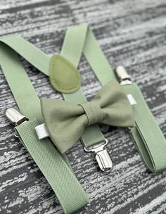 "Elevate your style with our exquisite Eucalyptus Moss Green bow tie , suspenders or pocket square   . Perfect for weddings , prom , Quinceañeras , and all Your special occasions - our accessories add a touch of sophistication to any outfit . Complete your ensemble and make a statement , whether you're a groom , groomsmen or ring bearer .  When making a purchase , you have the freedom to choose from the following options : - Bow tie only  - Suspenders only  - Bow tie + Suspenders  -Pocket square only  Attention all buyers ! We understand how important it is to get perfect color - to insure your complete satisfaction , we now offer free color samples for all our products before purchase . Please note that due to our policy , returns based solely on color discrepancy will not be accepted . Rustic Wedding Outfit, Sage Green Bow Tie, Ring Bearer Ideas, Ring Bearer Suit, Ring Bearer Gift, Ring Bearer Boy, Toddler Suits, Ring Bearer Gifts, Green Bow Tie