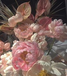 some pink and white flowers are in a vase